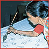 

   Hand painting   
   the batik
   with hot wax

